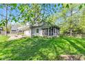 Quaint home featuring a screened-in porch, wooden deck and a spacious yard perfect for outdoor activities at 8190 Jordan Ln, Indianapolis, IN 46240