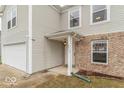Inviting entrance to a two-story home featuring a covered porch and brick accents at 8444 Ash Grove Dr, Camby, IN 46113