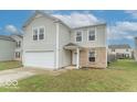 Charming two-story home with a neatly maintained lawn and a front-facing garage at 8444 Ash Grove Dr, Camby, IN 46113