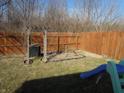 Enclosed backyard featuring a wooden fence, grass and play structure at 8848 Hosta Way, Camby, IN 46113