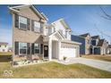 Beautifully landscaped two-story home featuring a two-car garage and inviting entryway at 10202 Meadow Path Ln, Indianapolis, IN 46239