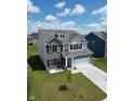 Attractive two-story home boasts a well-maintained lawn, a two-car garage, and decorative shutters at 10202 Meadow Path Ln, Indianapolis, IN 46239