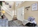 Bright foyer with hardwood floors, a staircase, and stylish decor that complement the space at 10518 Cornelian Ct, Noblesville, IN 46060