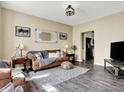 Comfortable living room with a plush sofa, neutral walls, and a view to the kitchen at 10518 Cornelian Ct, Noblesville, IN 46060