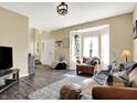 Cozy living room with a view of the foyer and a large window with natural light at 10518 Cornelian Ct, Noblesville, IN 46060
