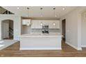 Modern kitchen with white cabinets, stainless steel appliances, and quartz countertops at 1101 Knoll Ct, Greenwood, IN 46143