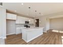 Modern kitchen with white cabinets, stainless steel appliances, and quartz countertops at 1101 Knoll Ct, Greenwood, IN 46143