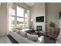 Airy living room features a fireplace, large windows, and a comfortable seating area at 1101 Knoll Ct, Greenwood, IN 46143