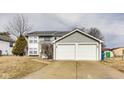 Classic two-story home with gray siding and an attached two-car garage in a suburban setting at 11410 Dunshire Dr, Indianapolis, IN 46229