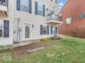 A backyard view with a small patio, a well-maintained lawn, and classic siding at 11936 Esty Way, Carmel, IN 46033