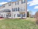 Backyard view showcasing a cozy balcony, green lawn, and ample space for outdoor enjoyment at 11936 Esty Way, Carmel, IN 46033
