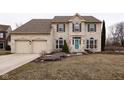 Attractive two-story brick home with a two-car garage and a cheerful blue front door at 11937 Cross Country Ct, Fishers, IN 46037