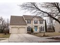 Charming two-story brick home with tidy landscaping and a two-car garage at 11937 Cross Country Ct, Fishers, IN 46037
