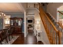 Inviting foyer with hardwood floors, staircase, and view to dining and living areas at 11937 Cross Country Ct, Fishers, IN 46037