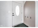 Bright entryway featuring a white door with an oval window and coat hooks at 1208 W 8Th St, Anderson, IN 46016
