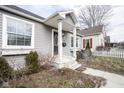 Charming single-story home featuring a covered entry and well-maintained landscaping at 1208 W 8Th St, Anderson, IN 46016