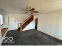 Open living room with staircase, large windows and a ceiling fan at 1342 W 18Th St, Indianapolis, IN 46202