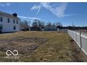 The large backyard of a two-story home is surrounded by a white picket fence at 13863 N Stiles Rd, Mooresville, IN 46158