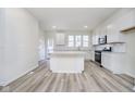 Bright kitchen features white cabinetry, stainless steel appliances, and a central island at 14568 Hanford Ln, Carmel, IN 46074