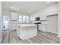 Modern kitchen boasts white cabinets, granite countertops, and stainless steel appliances at 14568 Hanford Ln, Carmel, IN 46074