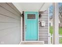 Close-up of a stylish turquoise front door with sidelights, enhancing curb appeal at 1804 Spann Ave, Indianapolis, IN 46203