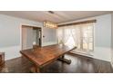 Bright dining room featuring a dark wood table, decorative light fixture and a large window at 2830 Moller Rd, Indianapolis, IN 46224