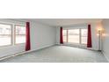 Spacious living room featuring large windows, neutral paint, and carpeted flooring at 2830 Moller Rd, Indianapolis, IN 46224