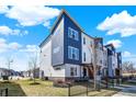Charming multi-level townhouse complex showcasing modern architectural design and well-maintained landscaping at 2945 Kirkbride Way, Indianapolis, IN 46222