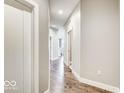 A brightly lit hallway with wood flooring and neutral-colored walls at 319 E 16Th E St # 201, Indianapolis, IN 46202
