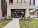 Building entrance with modern design, glass doors, and landscaping showcasing the building's clean lines and curb appeal at 319 E 16Th St # 302, Indianapolis, IN 46202
