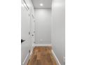 Bright hallway features wood floors, white trim and doors, offering a clean and modern aesthetic at 319 E 16Th St # 302, Indianapolis, IN 46202