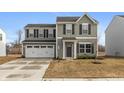 Two-story home featuring green siding, black shutters, a two-car garage and a concrete driveway at 3219 E Maygrove Dr, Danville, IN 46122