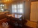 Cozy dining area with hardwood floors and a large window for natural light at 3337 Nottingham Dr, Columbus, IN 47203