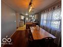 Cozy dining area with hardwood floors and a large window for natural light at 3337 Nottingham Dr, Columbus, IN 47203