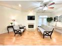 Bright living room featuring a fireplace, ceiling fan, and access to a balcony at 355 E Ohio E St # 206, Indianapolis, IN 46204