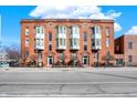 Stunning brick building exterior with bay windows, multiple entryways, and manicured landscaping at 402 E New York St # 302, Indianapolis, IN 46202
