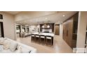 Open kitchen and dining area with a large island, modern pendant lights, and a view of the backyard at 4094 Chapel Hill Ct, Bargersville, IN 46106