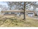 Charming single story home with stone accents, garage and a well-manicured lawn at 435 Howard Rd, Greenwood, IN 46142
