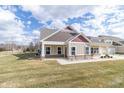 Attractive home with red accents, neutral siding, and a covered porch at 4408 W Preserve Pass, New Palestine, IN 46163