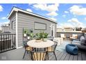 Cozy rooftop deck area with comfortable seating, a dining table, container plants and scenic views at 447 Leota St, Indianapolis, IN 46203