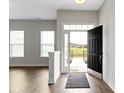 Bright entryway featuring hardwood floors, white trim, and a view of the outdoors at 517 Steinbeck Pl, Carmel, IN 46032