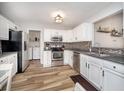 Modern kitchen showcasing stainless steel appliances, white cabinetry, and stylish backsplash at 5448 Montavia Cir, Indianapolis, IN 46239