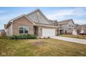 Well-maintained home with a two-car garage, landscaping and an inviting front yard at 5784 Cherrywood Ln, McCordsville, IN 46055