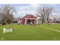 Quaint single-story home with a covered front porch and a spacious yard at 5902 Hardegan St, Indianapolis, IN 46227