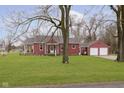 Inviting single-story home with a covered front porch and a detached garage at 5902 Hardegan St, Indianapolis, IN 46227