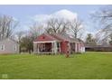 Attractive single-story home with a covered porch and a large, well-maintained lawn at 5902 Hardegan St, Indianapolis, IN 46227