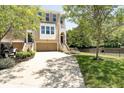 Attractive townhouse with a front lawn, long driveway, and attached garage at 651 Greenford N Trl, Carmel, IN 46032