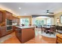 Spacious kitchen with stainless steel appliances, hardwood floors, and a central island at 651 Greenford N Trl, Carmel, IN 46032