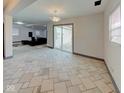 Bright living room with tile floors, sliding glass doors, and contemporary lighting fixtures at 6780 N Michigan Rd, Fairland, IN 46126