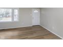 Neutral living room showcasing new floors, big window and lots of light at 7803 Delbrook Dr, Indianapolis, IN 46260